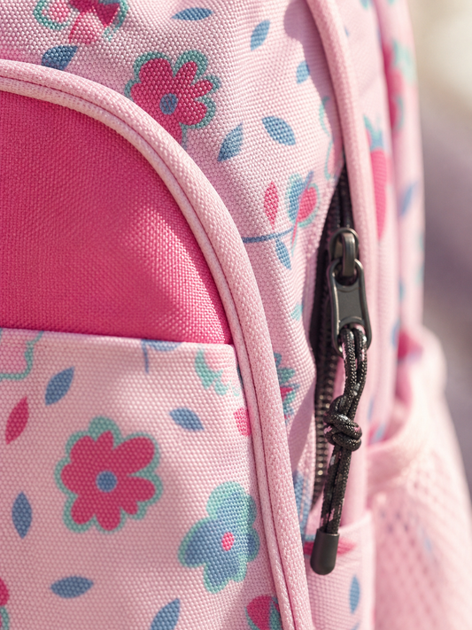 Macro texture detail of the pink flower print backpack fabric