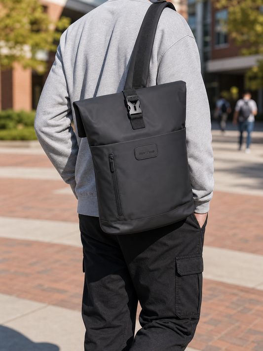 Black expandable roll-top laptop backpack worn over one shoulder on campus