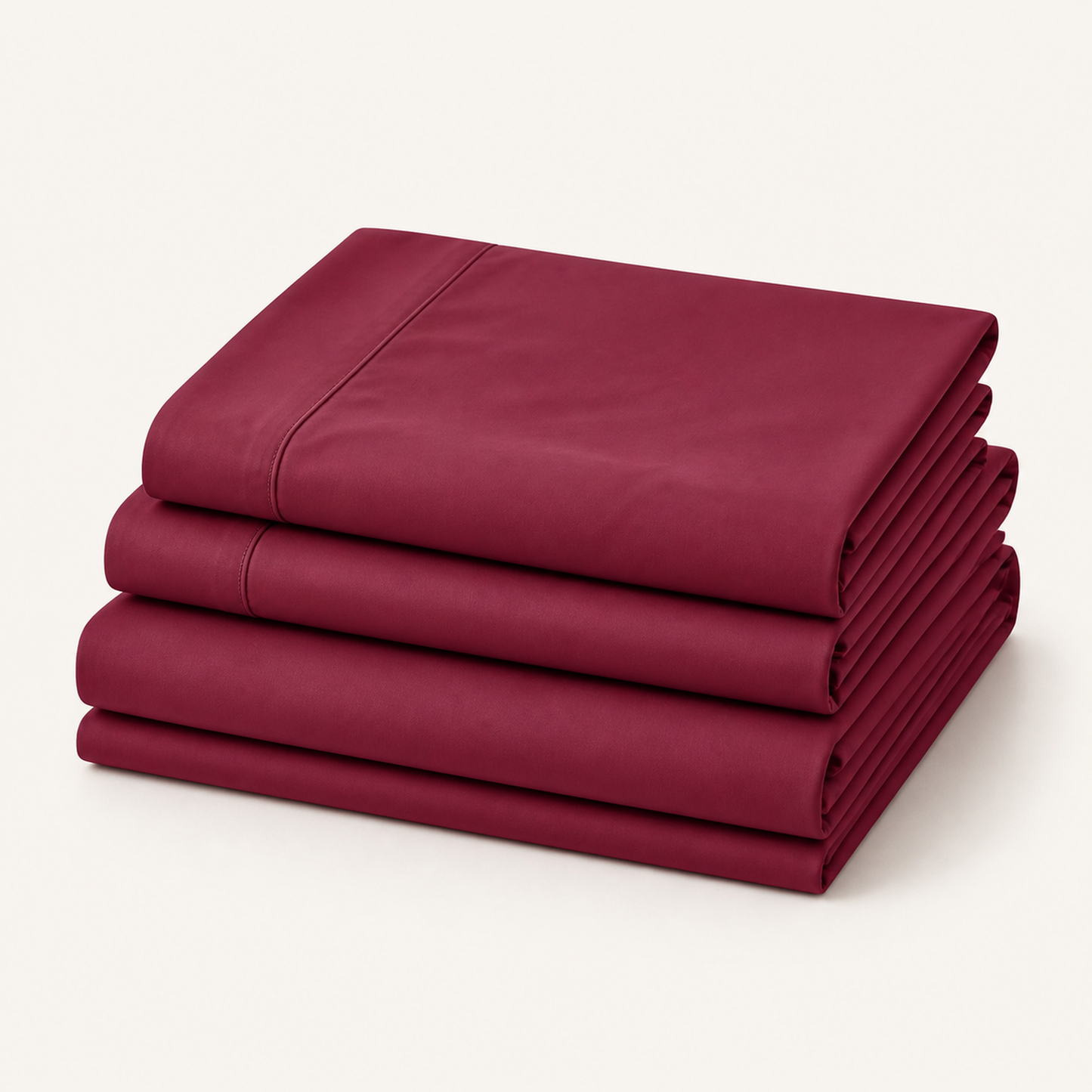 Burgundy 600 thread count percale Queen sheet set folded and stacked on a white background