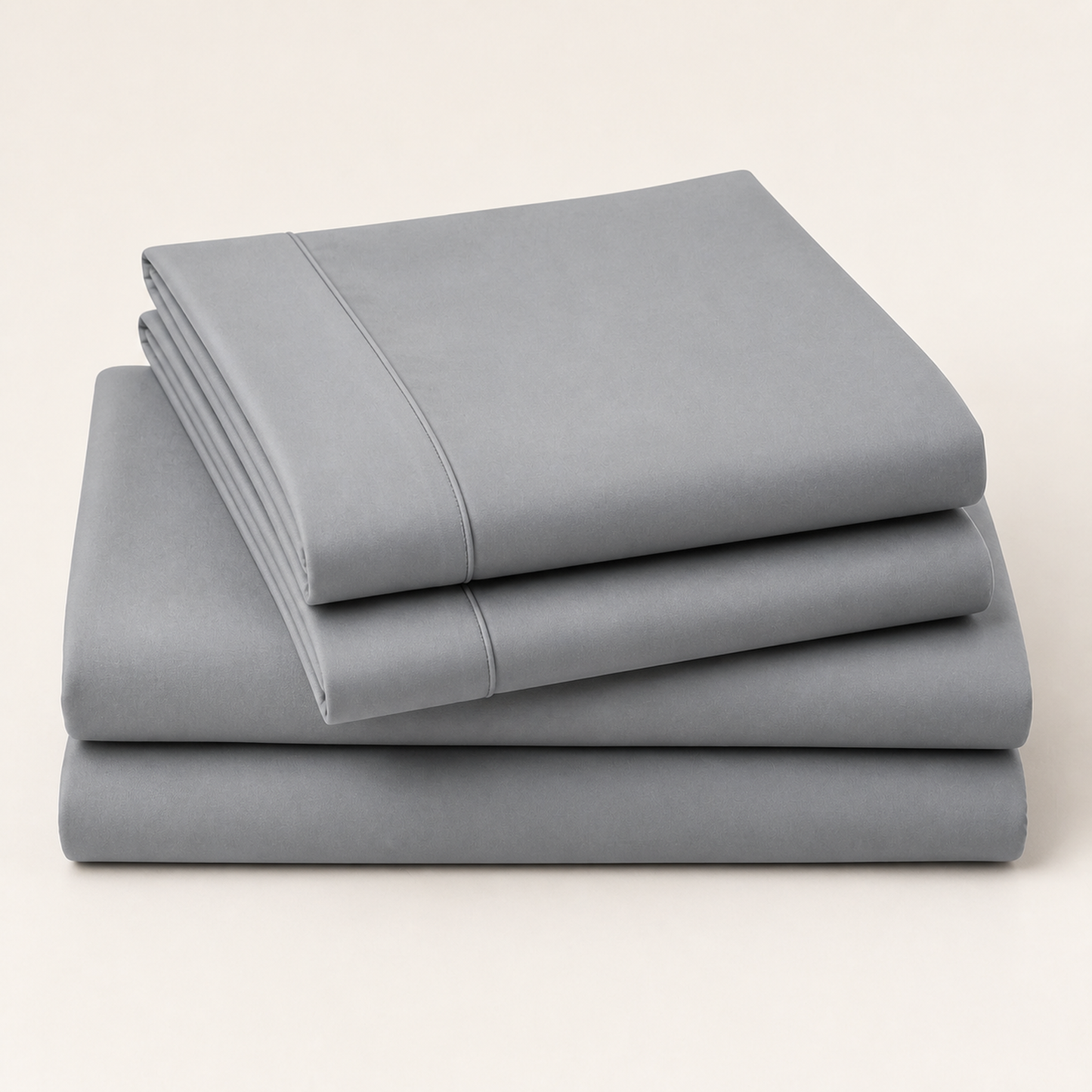 Grey 600 thread count percale Queen sheet set folded and stacked on a white background