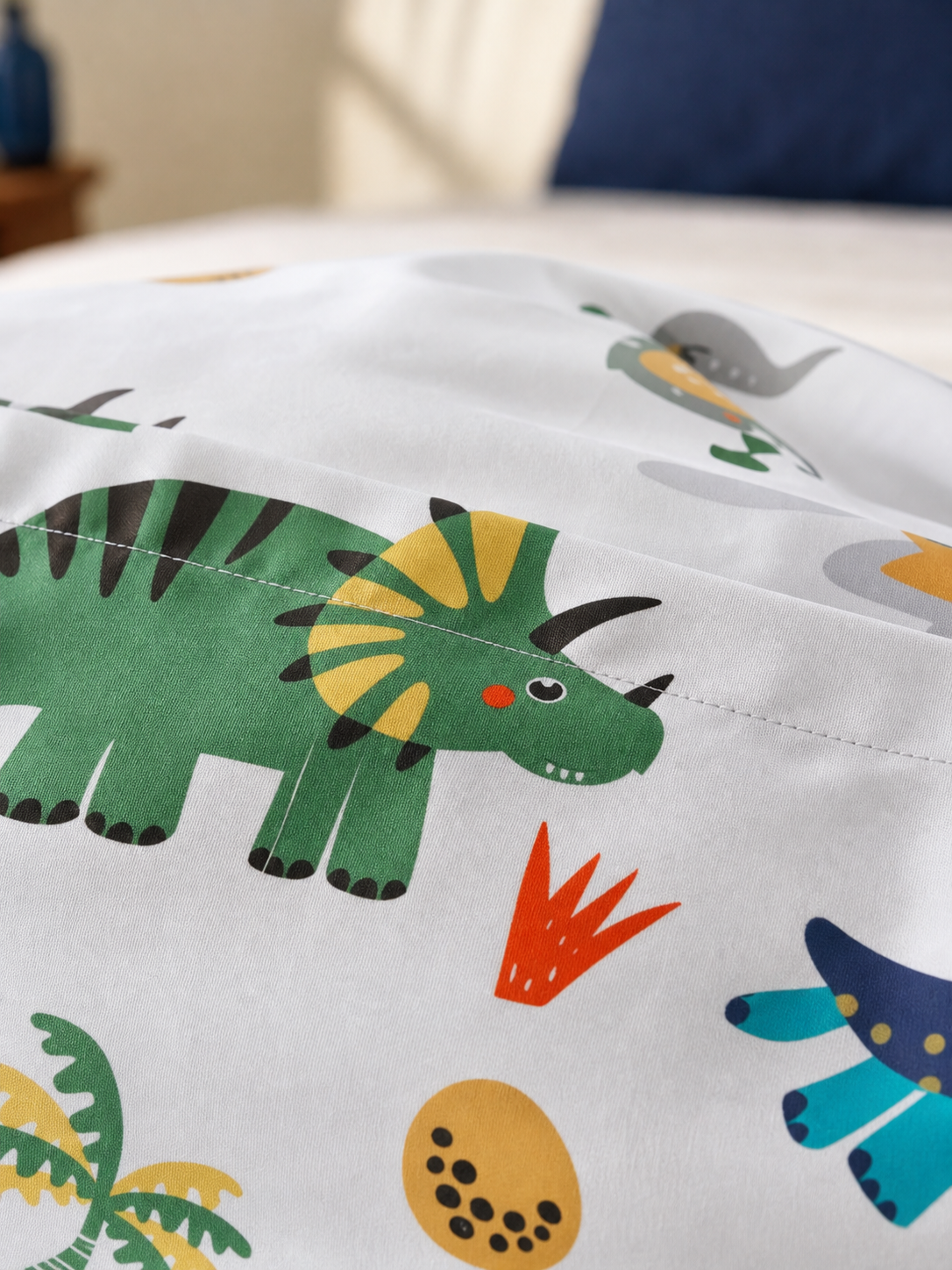 Fabric detail of the dinosaur print cotton blend