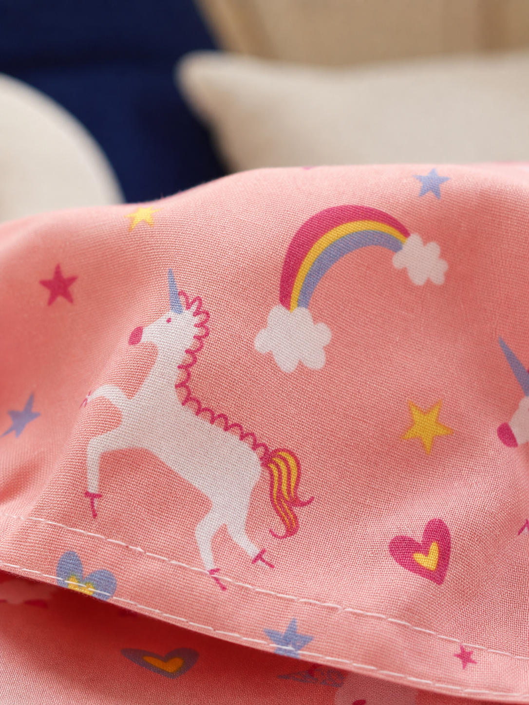 Fabric detail of the pink unicorn print cotton blend