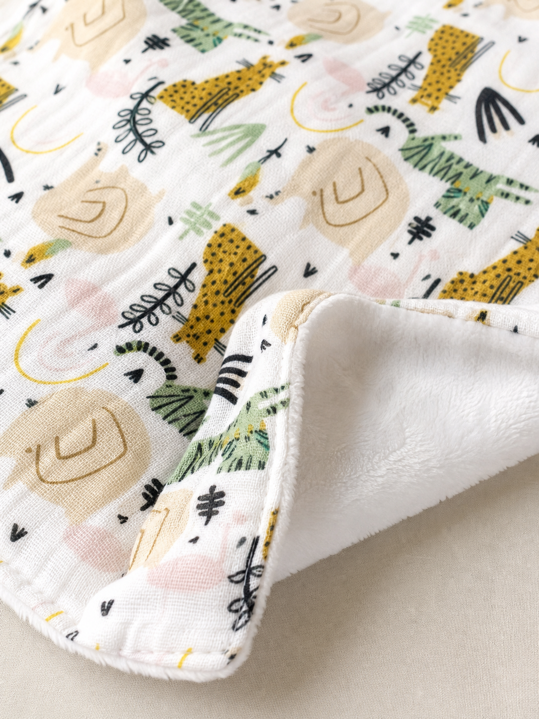 Macro detail of the muslin front and plush reverse of the blanket