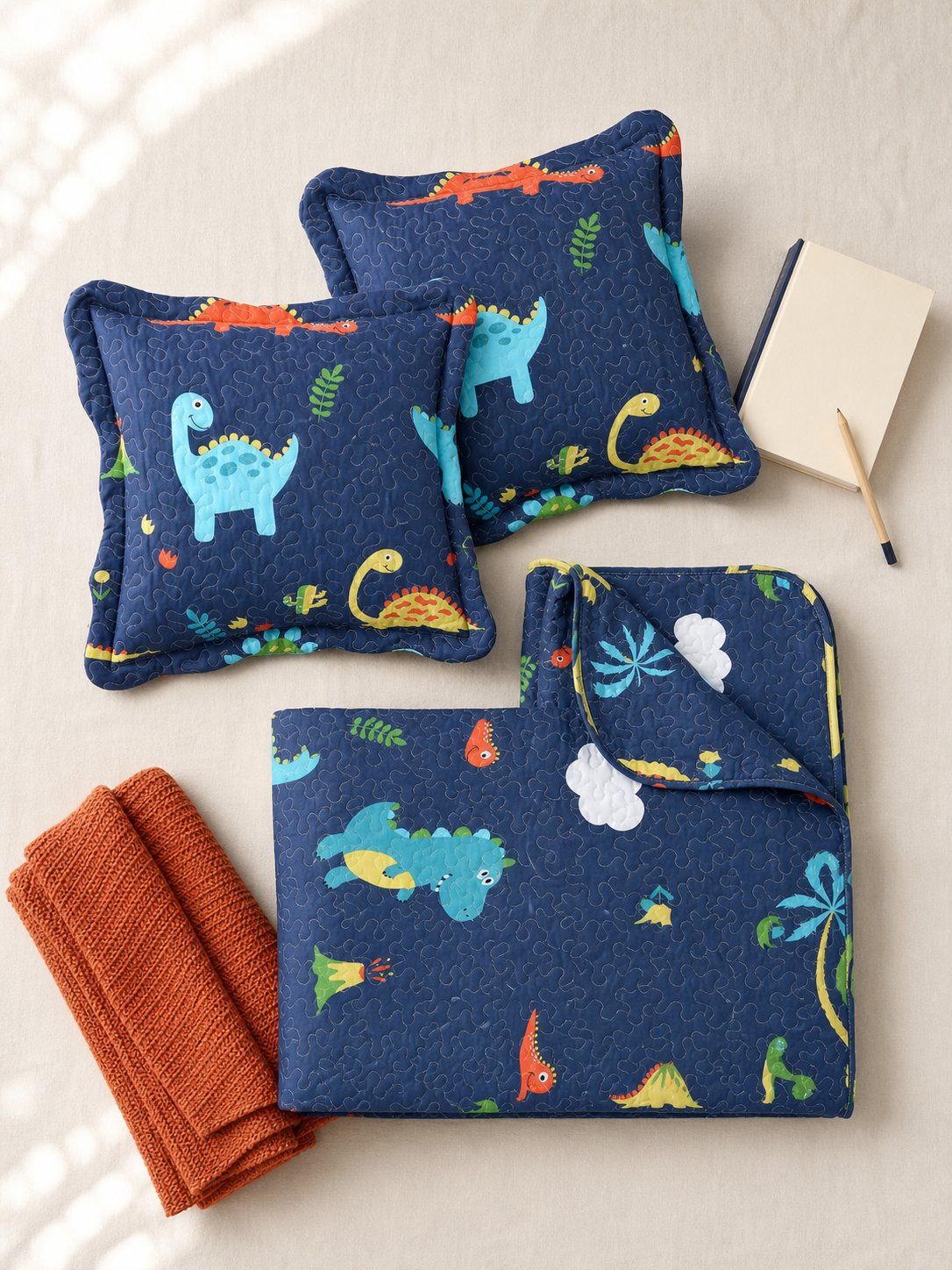 Flat lay of the dinosaur reversible Twin quilt set