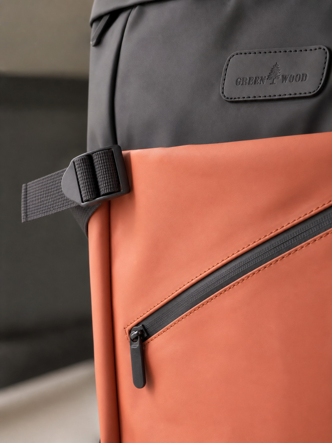 Zipper and hardware texture detail on the tan roll-top backpack