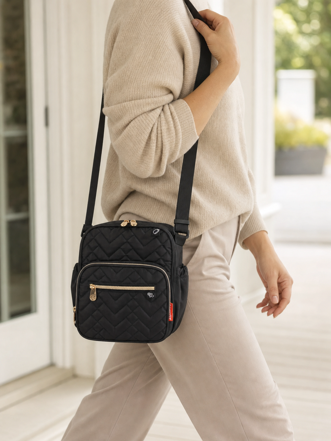 Black cooler bottle bag carried over one shoulder