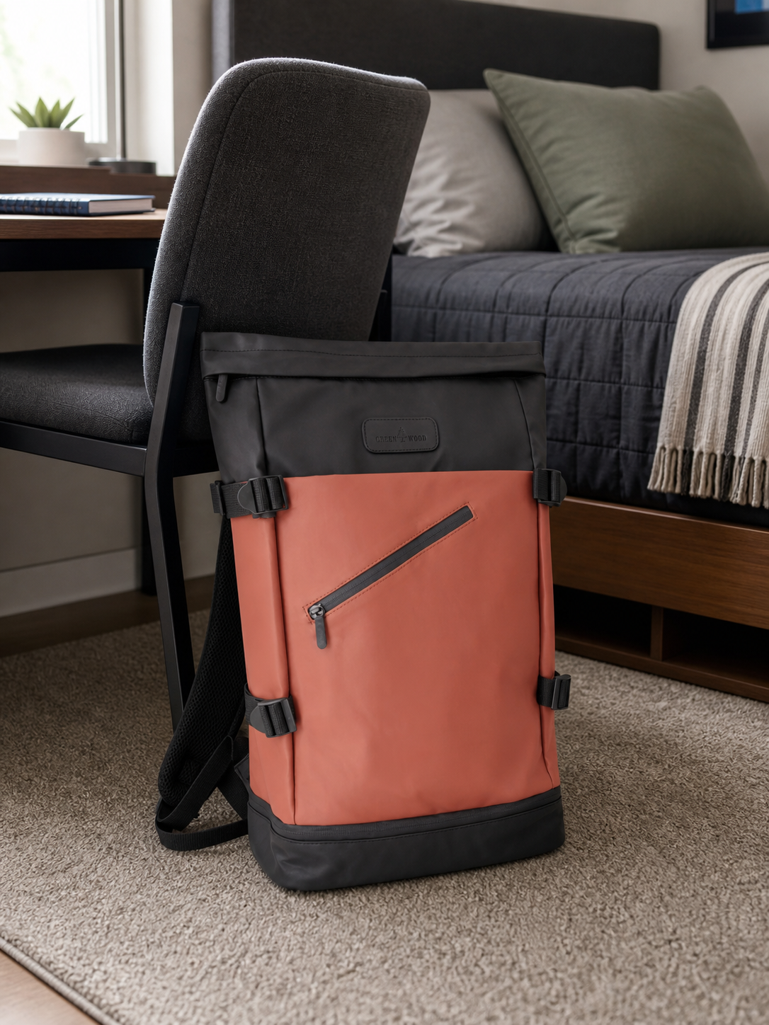 Tan roll-top backpack styled on a dorm room chair