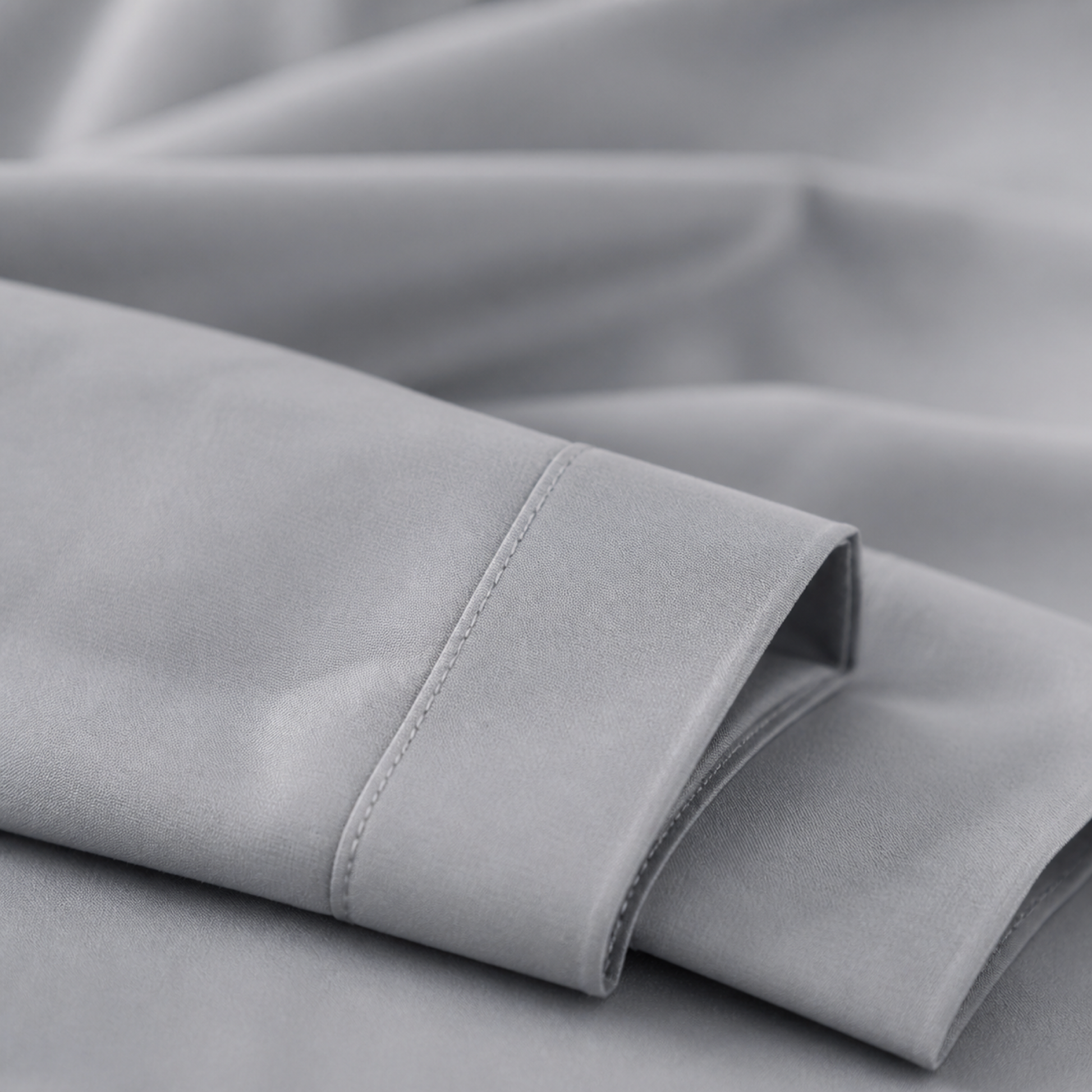 Close-up of the silver 600 thread count percale weave and stitched hem