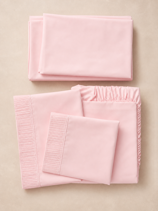 Flat lay of the pink 6-piece Queen sheet set with pleated pillowcases