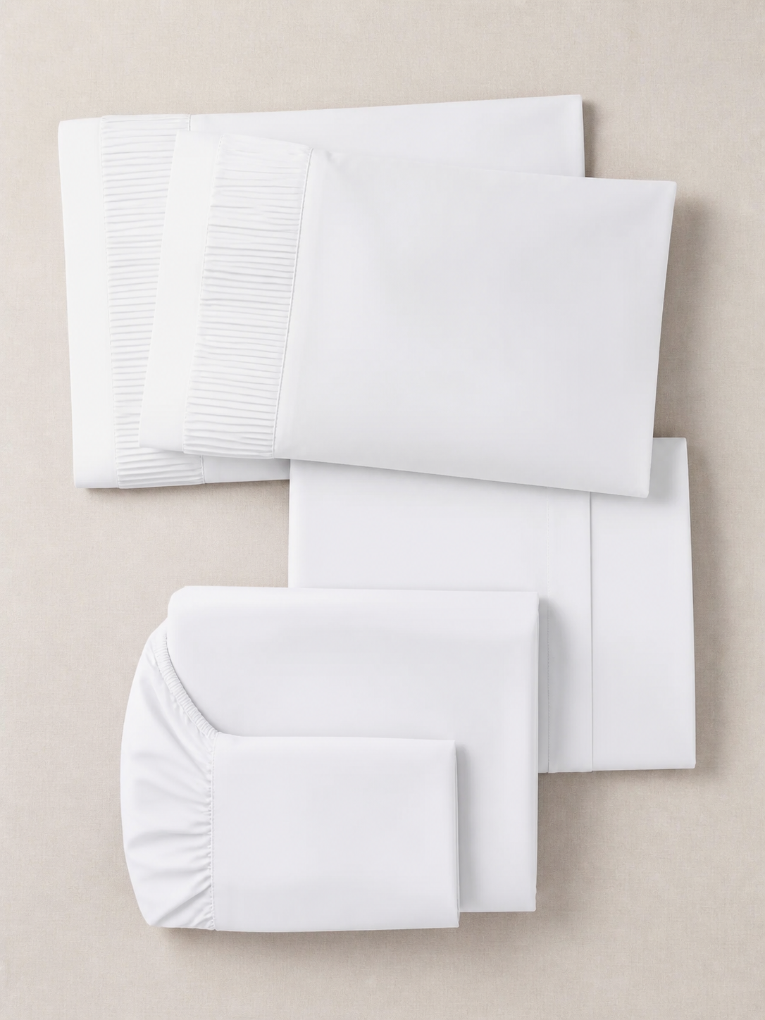 Flat lay of the white 6-piece Queen sheet set showing all six pieces