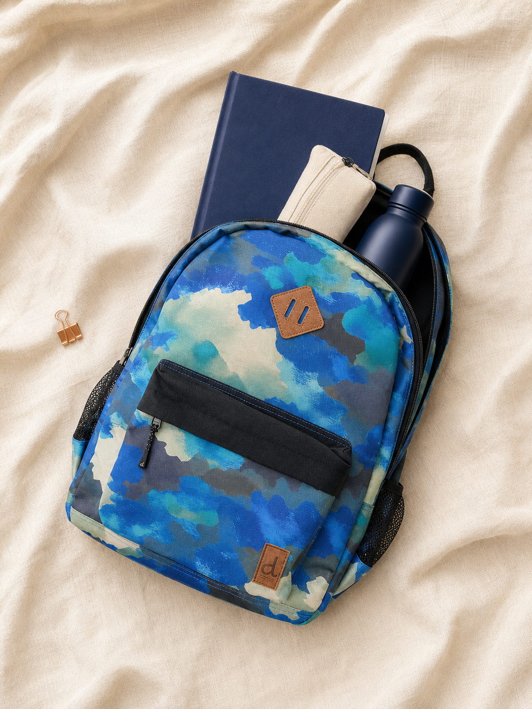Flat lay of the camouflage kids backpack with school supplies