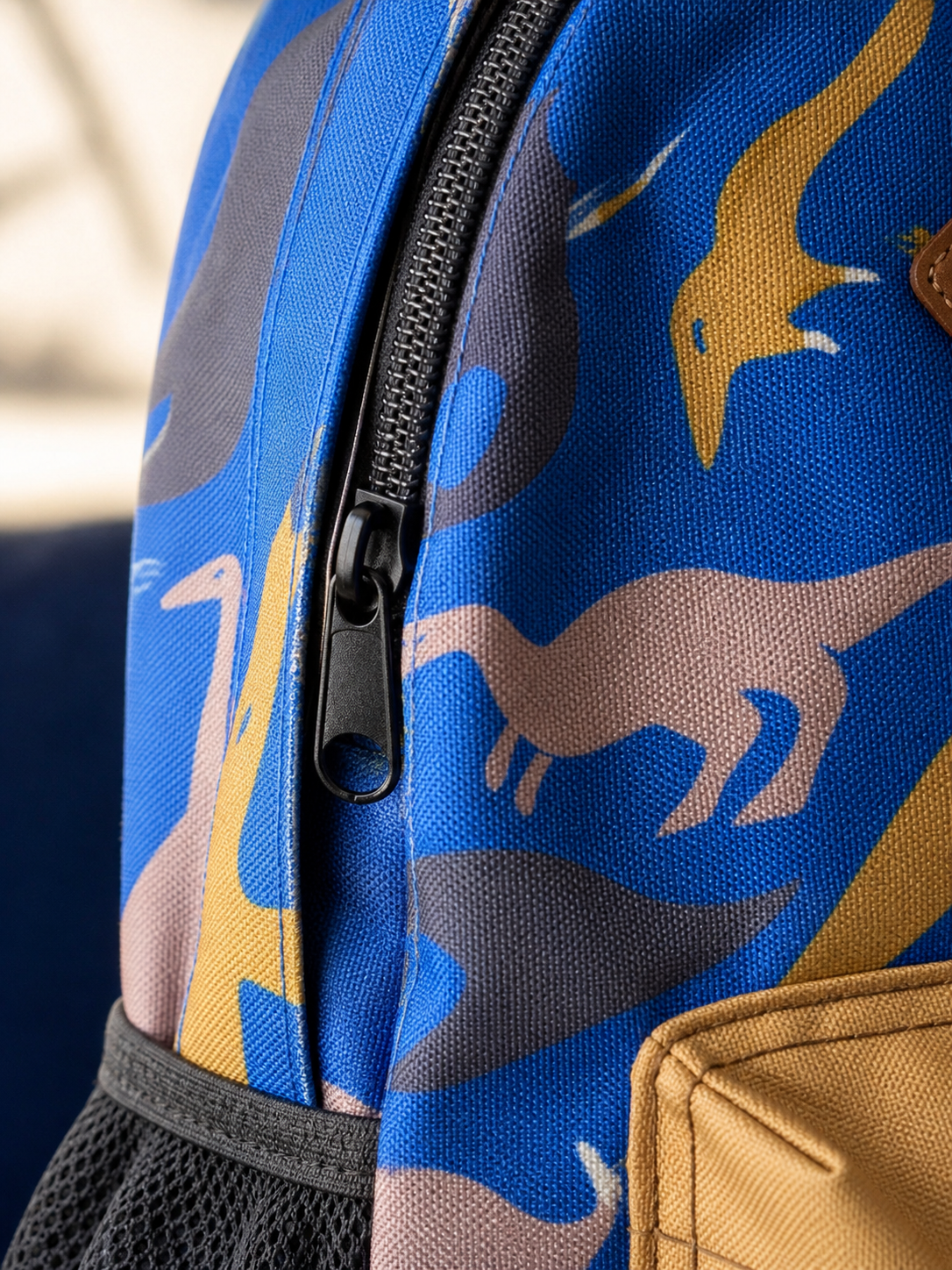 Macro texture detail of the blue dinosaur backpack fabric