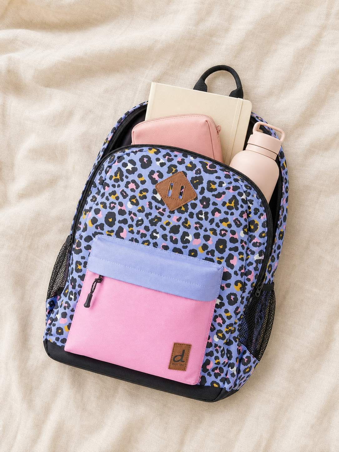 Flat lay of the leopard print kids backpack with school supplies