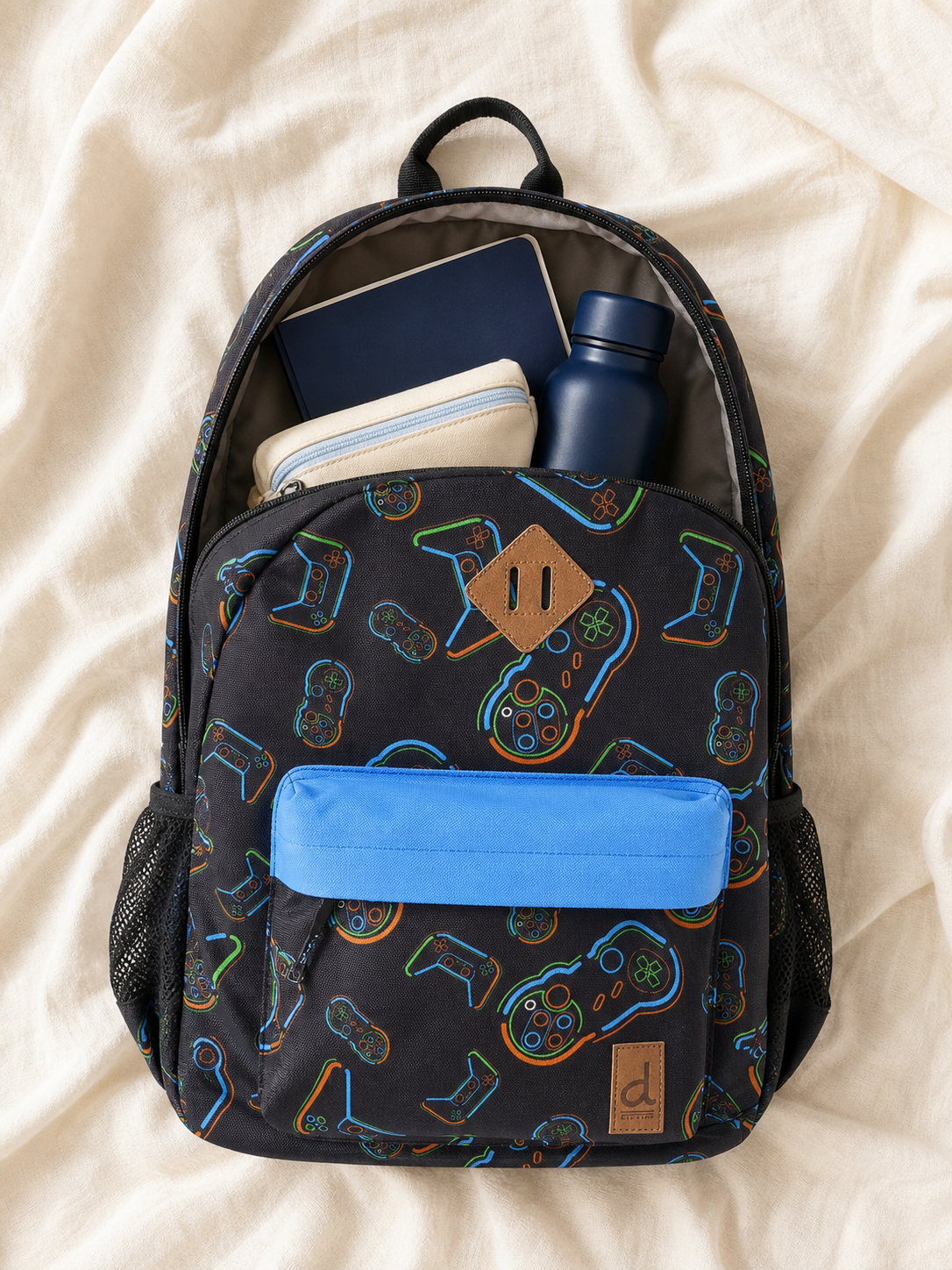 Flat lay of the controller print backpack with school supplies