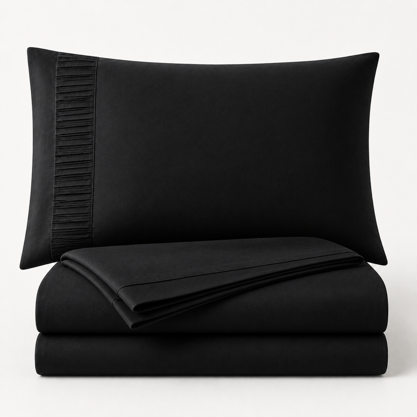 Black 4-piece Twin XL sheet set folded and stacked with pleated pillowcase on a white background