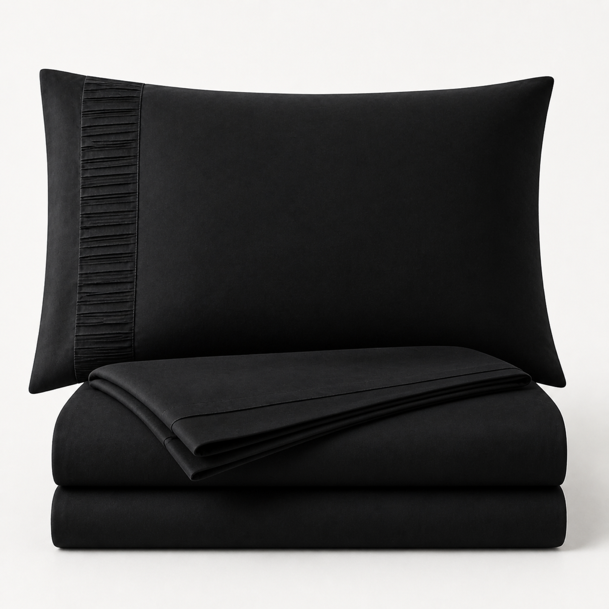 Black 4-piece Twin XL sheet set folded and stacked with pleated pillowcase on a white background