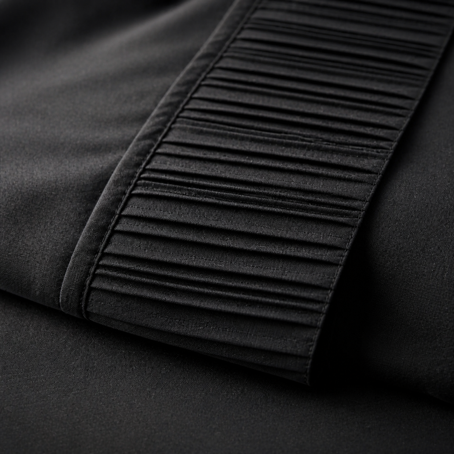 Close-up of the pleated trim on the black Twin XL pillowcase