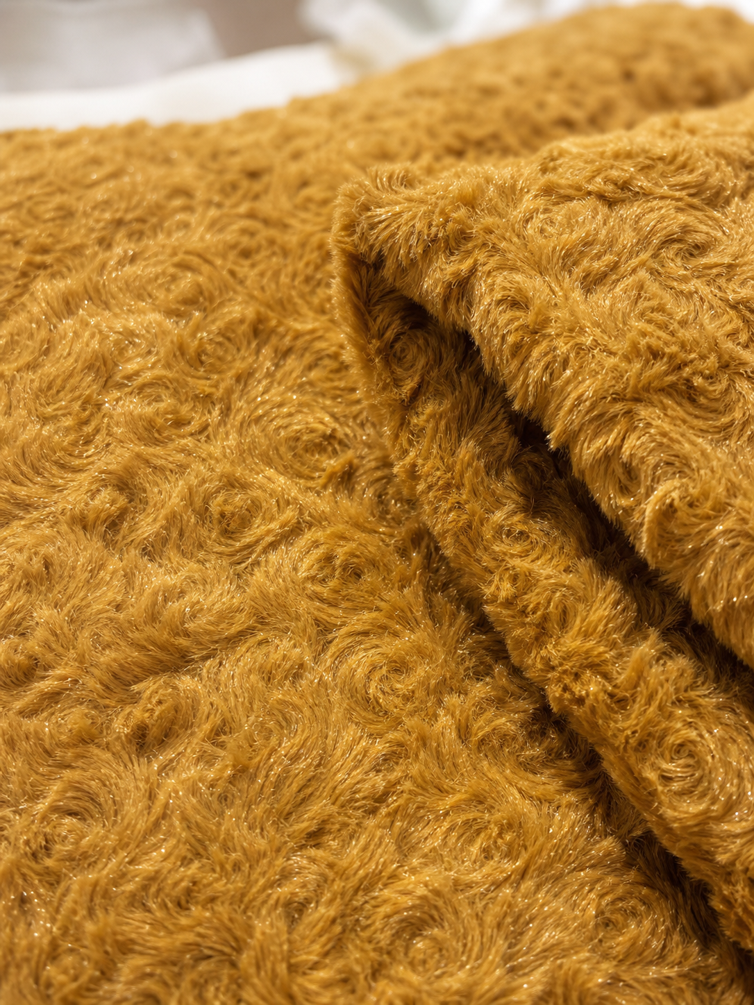 Close-up of the caramel rosette sherpa texture