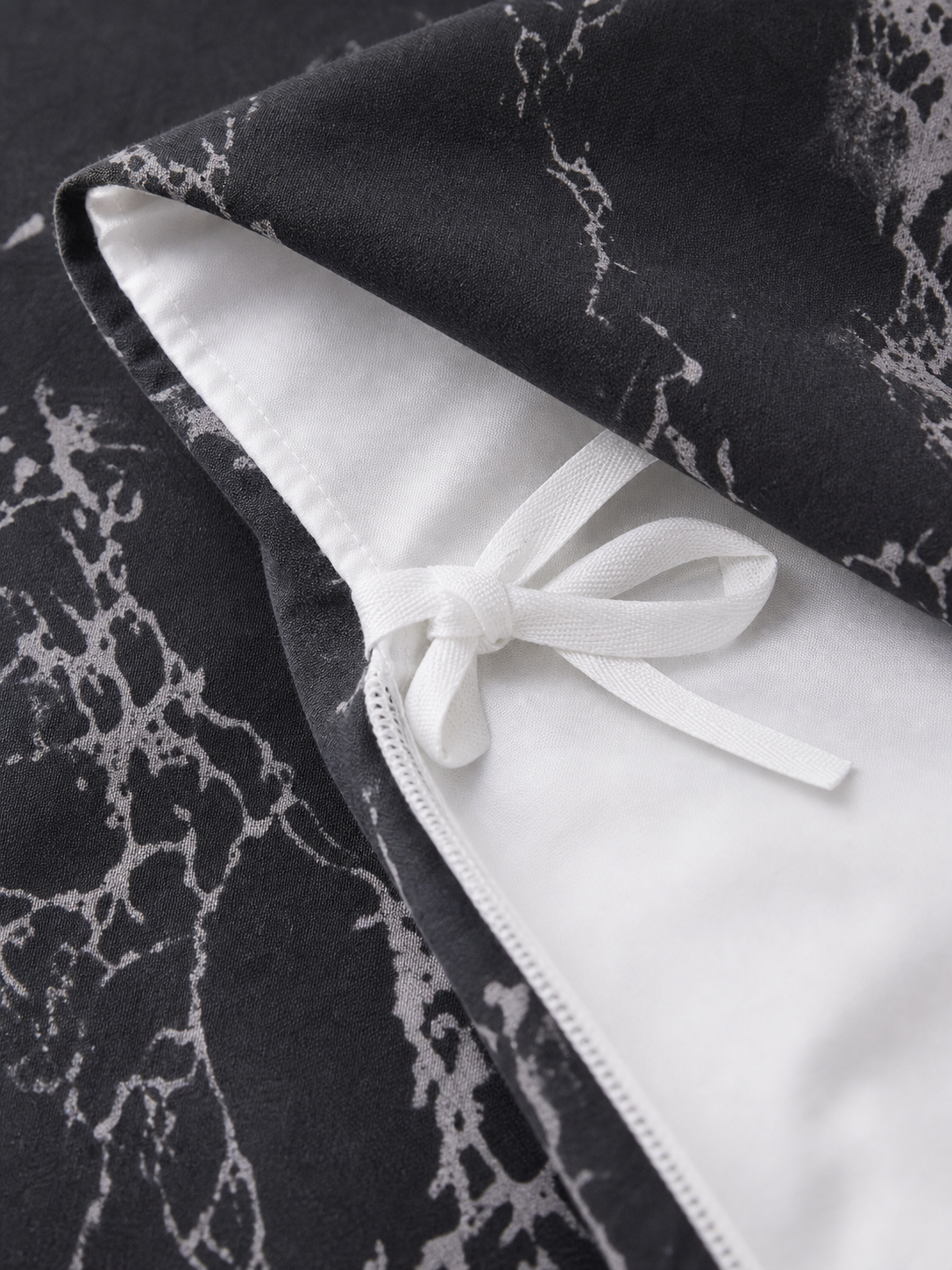 Interior corner ties on the marble Queen duvet cover