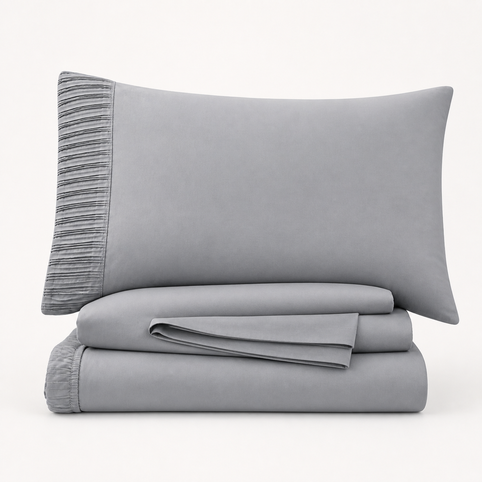 Grey 4-piece Twin XL sheet set folded and stacked with pleated pillowcase on a white background