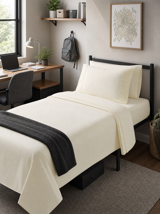 Included in the bundle: 4-piece Twin XL sheet set in ivory, made up on a residence bed