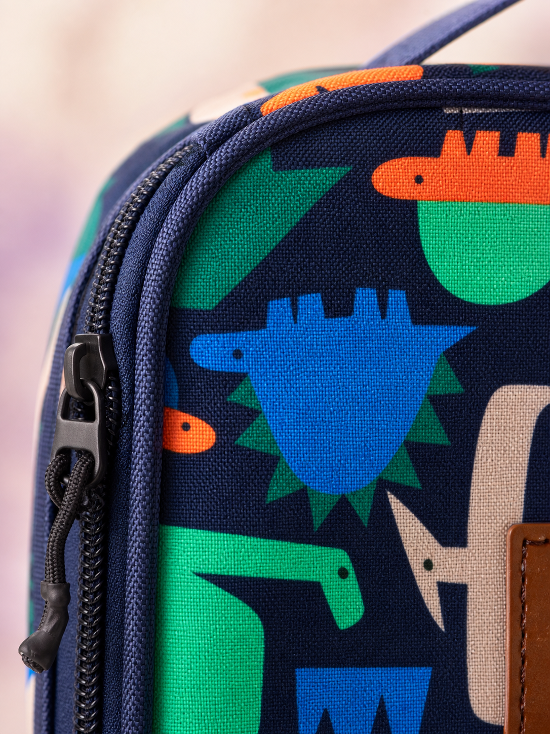 Macro texture detail of the dinosaur print snack box fabric