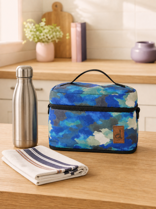 Blue and grey camouflage insulated lunch box on a kitchen counter