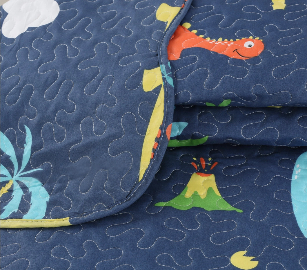 Dinosaur quilt set styled in a kid's bedroom